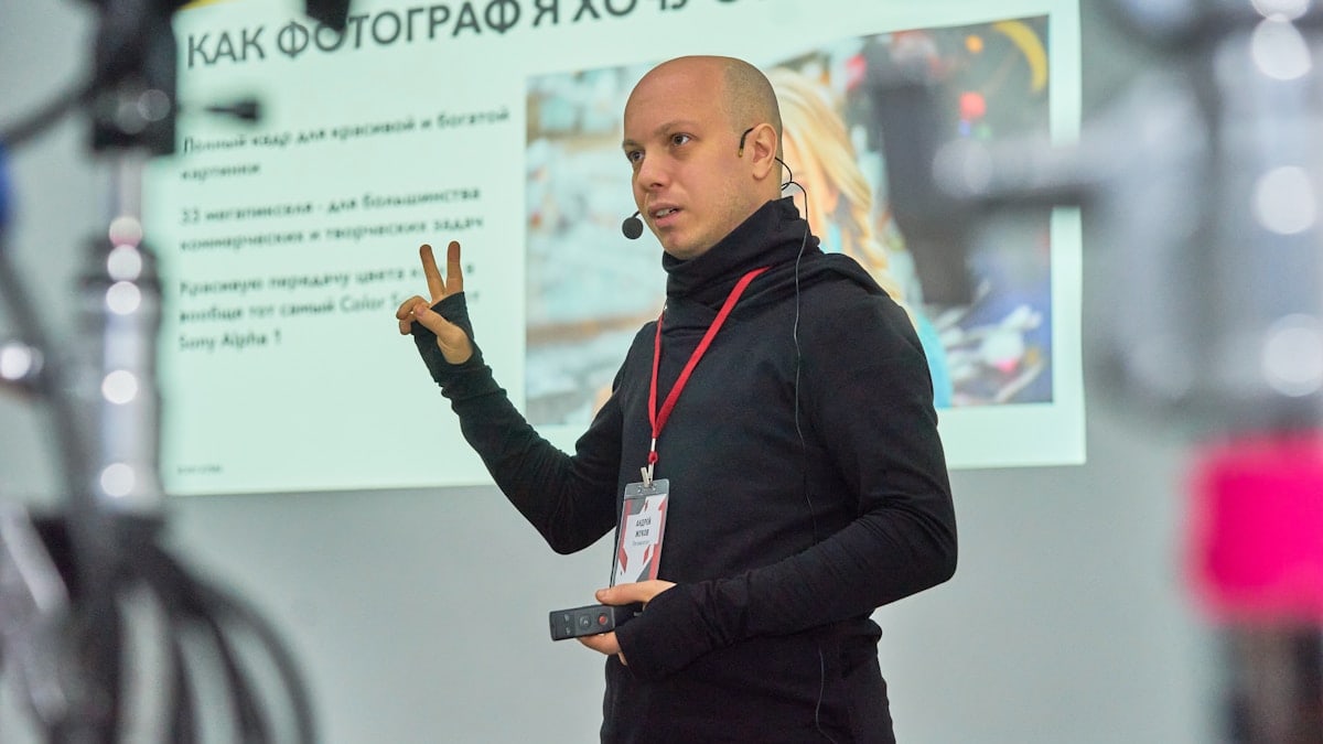 A man standing in front of a projector screen
